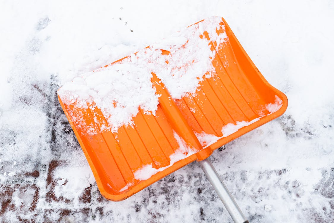 An image of an orange snow shovel