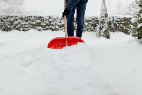 An image of a person using a shovel to remove snow