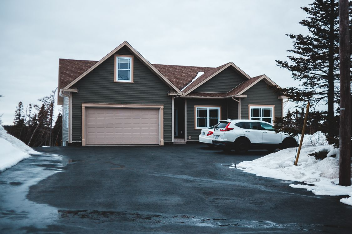 Residential driveway cleared of snow during winter, illustrating safe surface maintenance practices and environmentally responsible ice control methods for homeowners