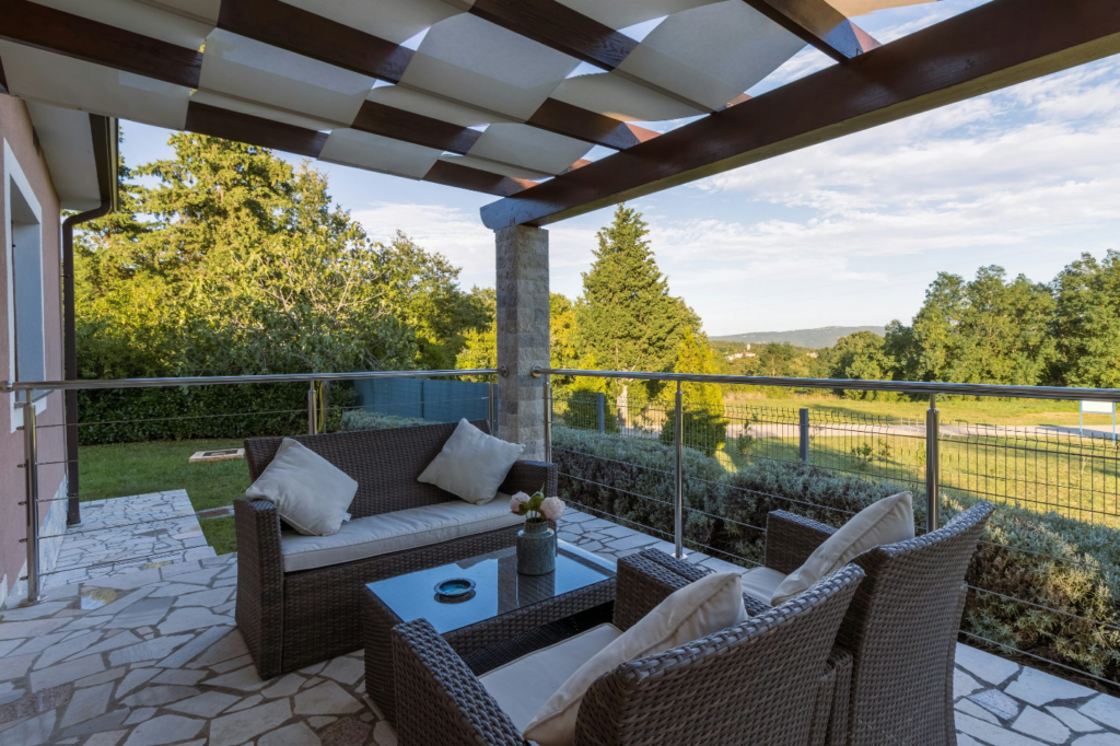 Custom stone patio with outdoor seating and landscaped garden