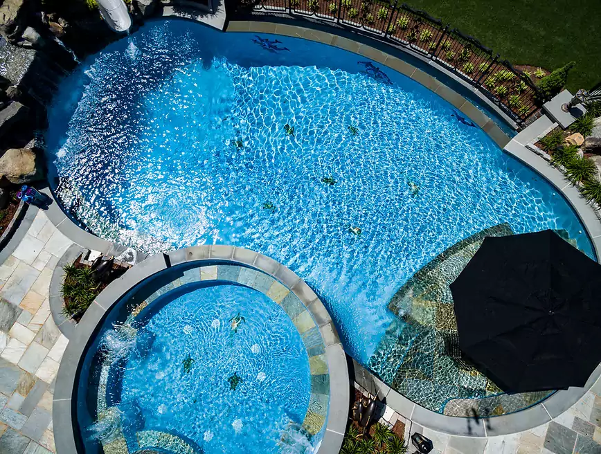 An image of a house with a huge swimming pool