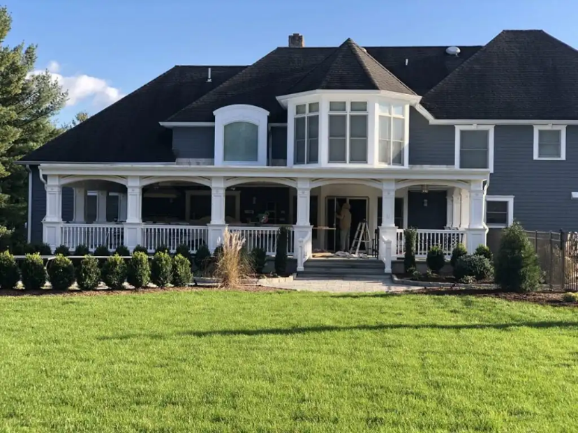 An image of a modern house with a lush lawn