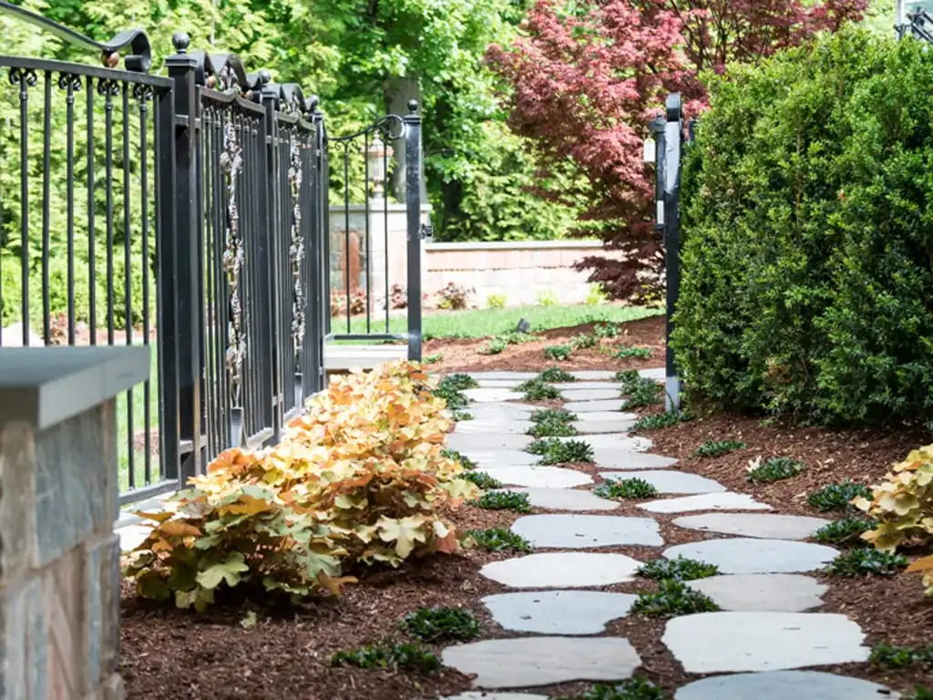 Fresh mulch covering a landscaped plant bed around trees and garden plants